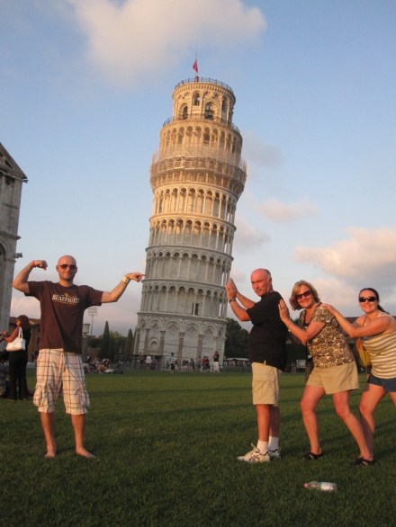 Family holding up leaning tower of Pisa