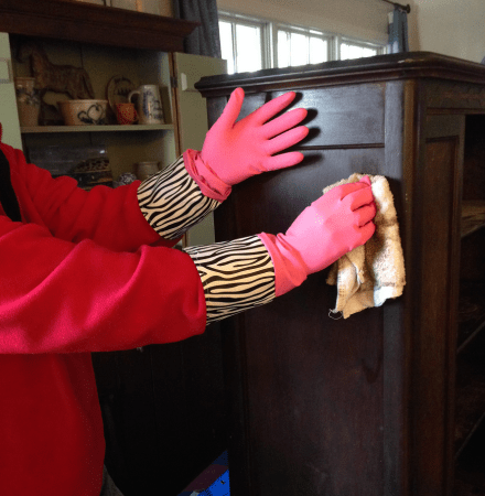 Coach cleaning the cupboard