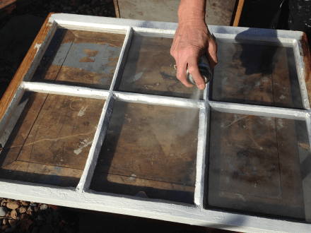 Spraying window with Krylon Looking Glass Mirror Paint